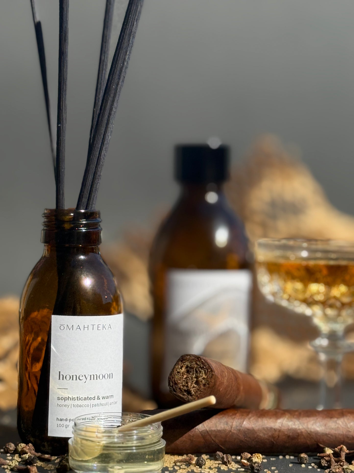 Parfum sofisticat de cameră – Honeymoon de la Omahteka, cu miere, tutun și accente lemnoase, cu bețișoare din ratan.